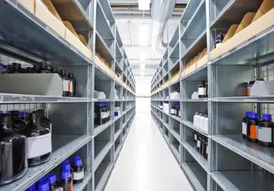 a stock room with metal shelves lining each side